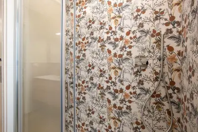 a shower curtain with a floral pattern on it at Aurelius Design Loft 2 in Rome