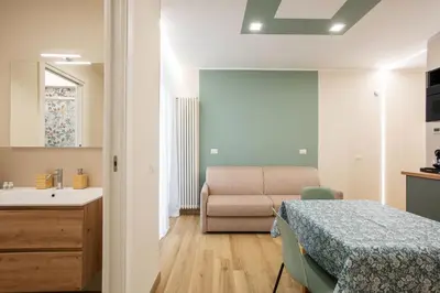 a bedroom with a bed and a bathroom with a sink at Aurelius Design Loft 2 in Rome