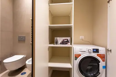 a small bathroom with a washing machine in it at Elegance and Style near St Peter's in Rome