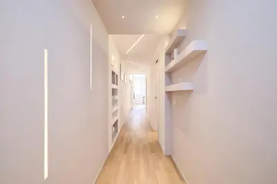 a hallway with white walls and wooden floors at Elegant Apartment near the Centre - Wi-Fi & Netflix Free in Rome