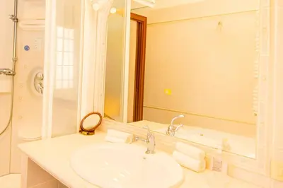 a bathroom with a sink and a mirror and a tub at Hi HOME in Rome