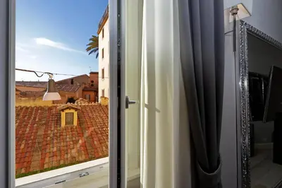 a window with a view of a roof at Sistina Twentythree luxury rooms in Rome