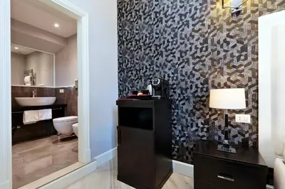 a bathroom with a toilet and a sink at Sistina Twentythree luxury rooms in Rome