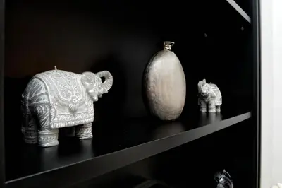 a shelf with figurines of elephants and a vase at Sistina Twentythree luxury rooms in Rome