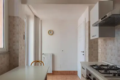 a room with a window and a chair and a book shelf at GuestHost - Terrace Apartment Nomentano - Roma in Rome