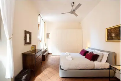 a bedroom with a bed and a ceiling fan at Secret place in the heart of ancient Trastevere in Rome