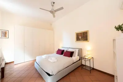 a bedroom with a bed and a ceiling fan at Secret place in the heart of ancient Trastevere in Rome