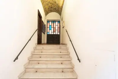 a stairway leading to a door in a building at Secret place in the heart of ancient Trastevere in Rome