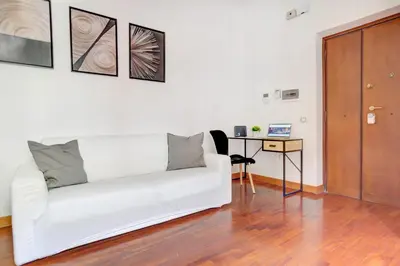 a bedroom with a large bed with a blue blanket at Colosseo Green Park - Home and More in Rome