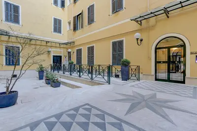 a hallway with a painting on the wall and four doors at Colosseo Green Park - Home and More in Rome