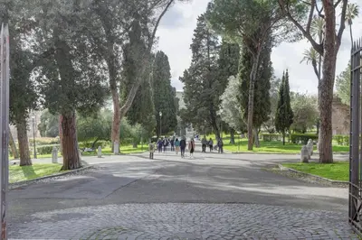 a group of people walking down a street in a park at Colosseo Green Park - Home and More in Rome
