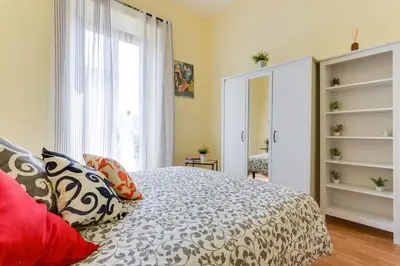 a bedroom with a bed with pillows and a window at Alice House al Vaticano in Rome