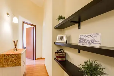 a room with black shelves and a hallway at Alice House al Vaticano in Rome