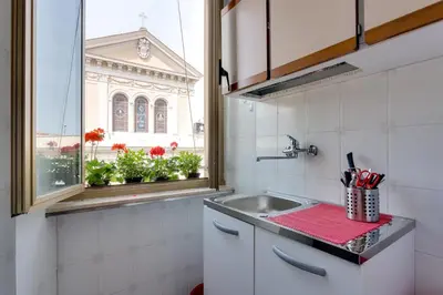 a kitchen with a sink and a window at Alice House al Vaticano in Rome