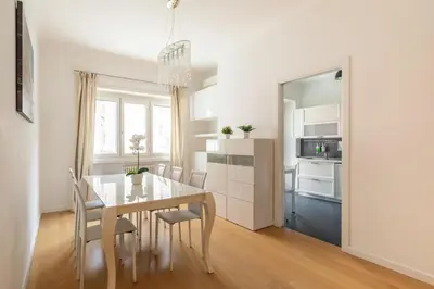 a kitchen and dining room with a table and chairs at Appartamento Elegante e Luminoso con Metro Vicina in Rome