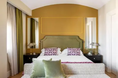 a bedroom with a large bed with pillows on it at HOTEL ADRIANO Rooftop in Rome