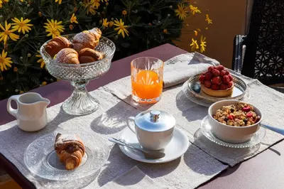 a table with a breakfast of pastries and coffee and orange juice at HOTEL ADRIANO Rooftop in Rome