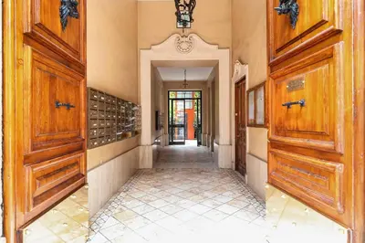 an empty hallway with wooden doors and aoyer with a hallwayngthngthngthngth at Appartamento Moderno nel Cuore di Roma in Rome