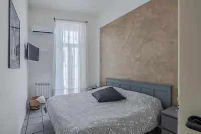 a bedroom with a bed with a pillow on it at Vibrant Trastevere 2 bedrooms on Via del Moro in Rome