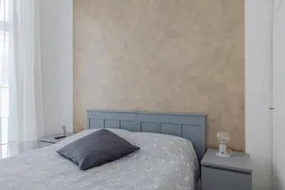 a bedroom with a bed with a pillow and two night stands at Vibrant Trastevere 2 bedrooms on Via del Moro in Rome
