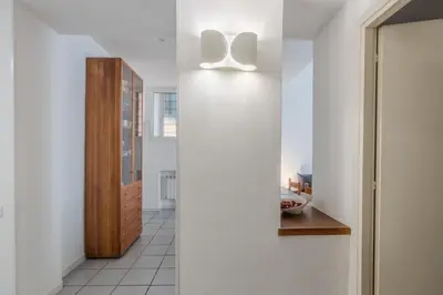 a hallway with white walls and a light fixture at Vibrant Trastevere 2 bedrooms on Via del Moro in Rome
