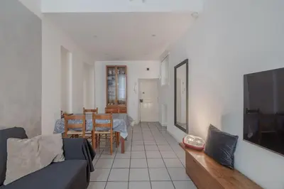 a living room with a couch and a television at Vibrant Trastevere 2 bedrooms on Via del Moro in Rome