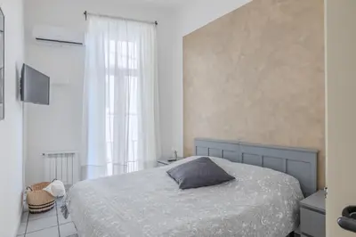 a bedroom with a bed with a gray pillow on it at Vibrant Trastevere 2 bedrooms on Via del Moro in Rome