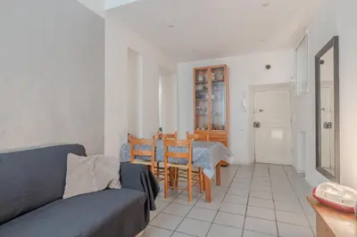 a living room with a couch and a table and chairs at Vibrant Trastevere 2 bedrooms on Via del Moro in Rome