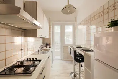 a kitchen with a sink and a stove top oven at San Pietro Appartamento Luminoso e Moderno in Rome