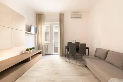 a living room with a couch and a table at San Pietro Appartamento Luminoso e Moderno in Rome