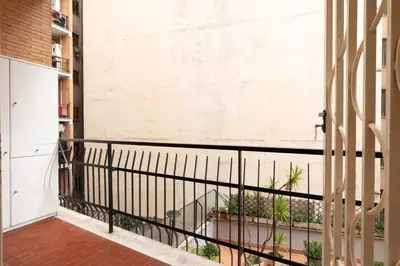 a balcony with a black railing and plants at Garbatella Appartamento Moderno Relax e Comfort in Rome