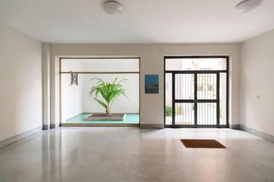 an empty room with a potted plant in the middle at Garbatella Appartamento Moderno Relax e Comfort in Rome