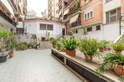 a courtyard in a building with potted plants at Garbatella Appartamento Moderno Relax e Comfort in Rome