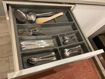a drawer filled with silver utensils in a kitchen at Loft with little backyard and patio in Rome