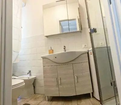 a bathroom with a sink and a toilet at Loft with little backyard and patio in Rome