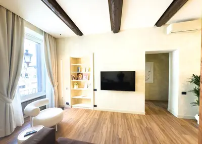 a living room with a television on a wall at Pantheon Urbes Collection in Rome