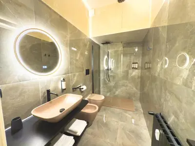 a bathroom with a sink and a toilet and a mirror at Pantheon Urbes Collection in Rome