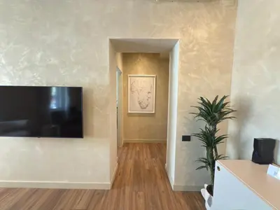 a living room with a flat screen tv on a wall at Pantheon Urbes Collection in Rome