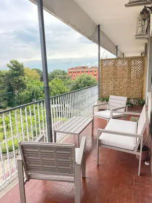 a balcony with benches and tables on a balcony at Edo's Rhome in Rome