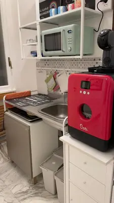 a kitchen with a red appliance on a counter at Edo's Rhome in Rome