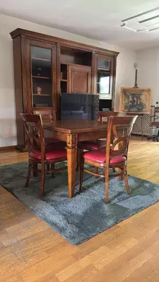 a wooden dining room table with two chairs and a table at Villa Domus Roma in Rome