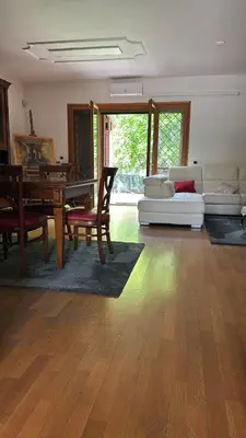 a living room with a table and a couch at Villa Domus Roma in Rome