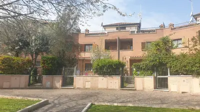 an apartment building with a fence in front of it at Villa Domus Roma in Rome