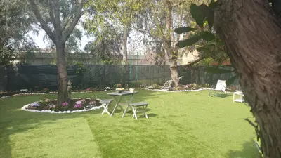 a garden with a table and chairs in the grass at Villa Domus Roma in Rome