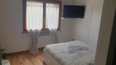 a small bedroom with a bed and a window at Villa Domus Roma in Rome