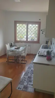 a kitchen with a table and a dining room at Villa Domus Roma in Rome
