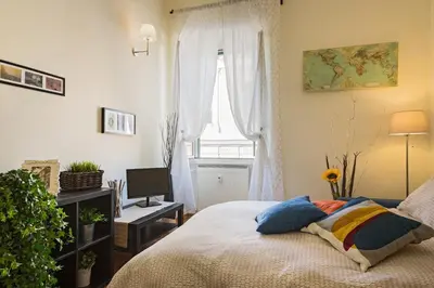 a bedroom with a bed and a window at Aly Apartment in Vatican in Rome