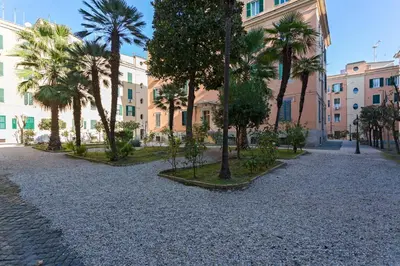a street with palm trees in front of a building at Aly Apartment in Vatican in Rome