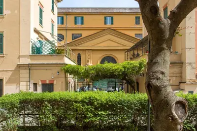 a building and a tree in front of a building at Aly Apartment in Vatican in Rome
