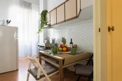 a kitchen with a table with fruit on it at Aly Apartment in Vatican in Rome